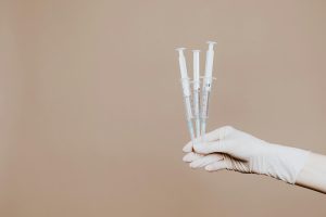 gloved hand holding semaglutide injections